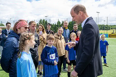 Prince William speaks with schoolchildren